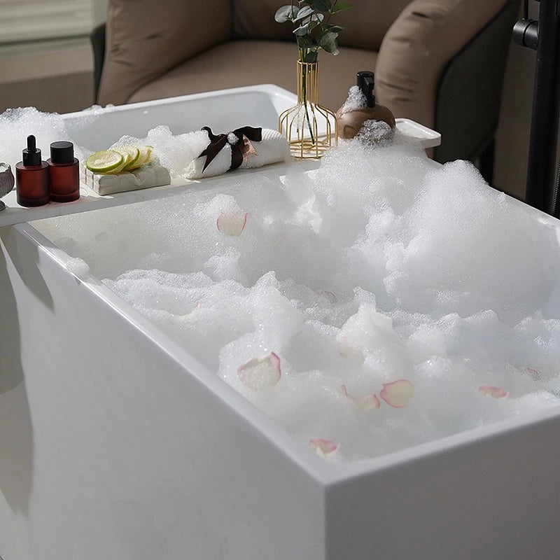 MonBlari white deep soaking bathtub filled with foam and flower petals