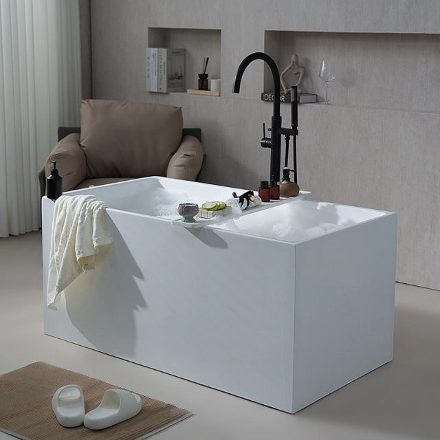 MonBlari white deep soaking bathtub in front side view with black floor-mounted faucet