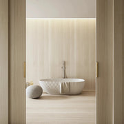 white solid surface bathtub with sculpted exterior lines