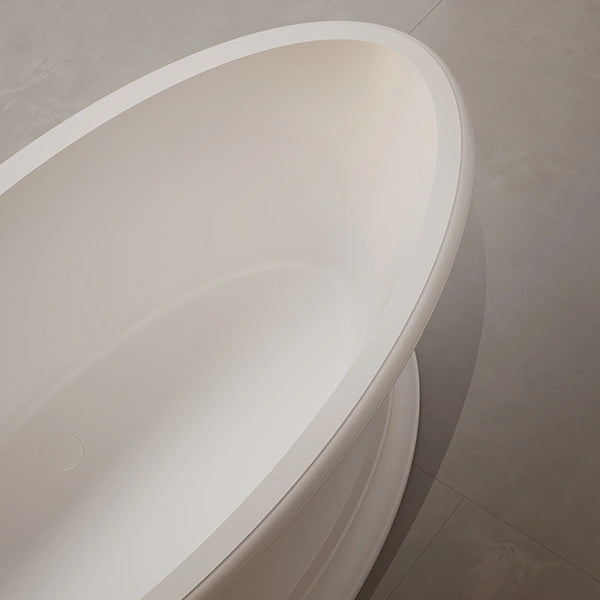 Deep soaking freestanding solid surface bathtub with seamless internal drain design