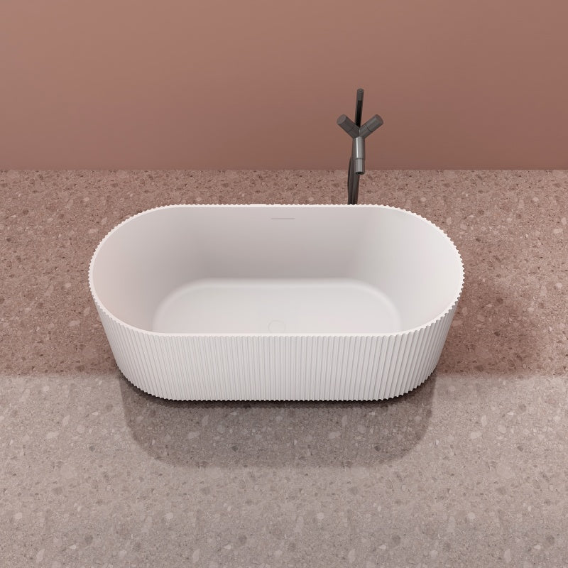 Modern fluted solid surface soaking tub with center drain