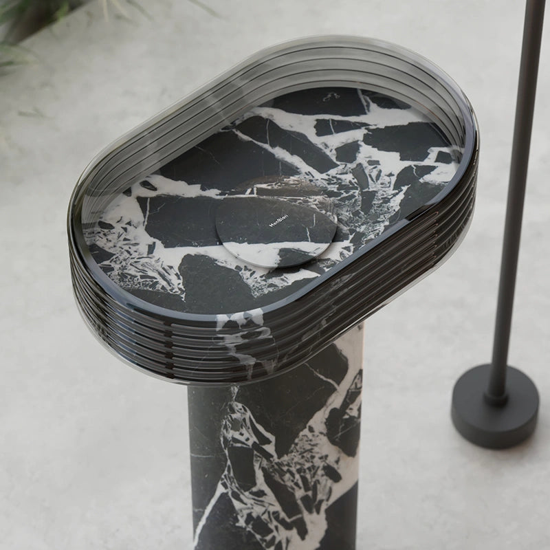 Sculptural marble bathroom sink with clear acrylic pedestal