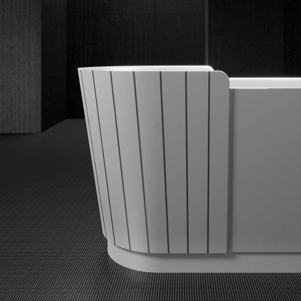 Modern freestanding soaking tub with integrated seat and sculptural design