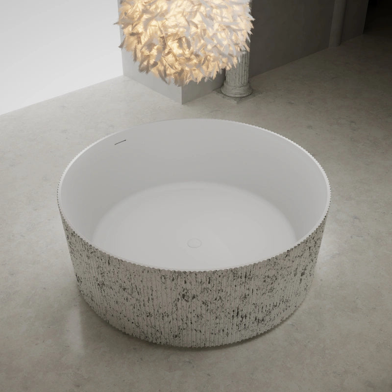 Round solid surface bathtub with sculptural fluted design for luxury bathroom