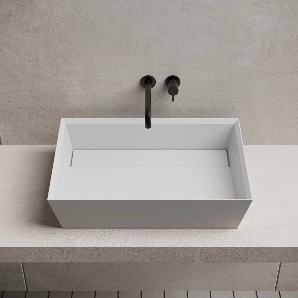 White rectangular solid surface wash basin front top view