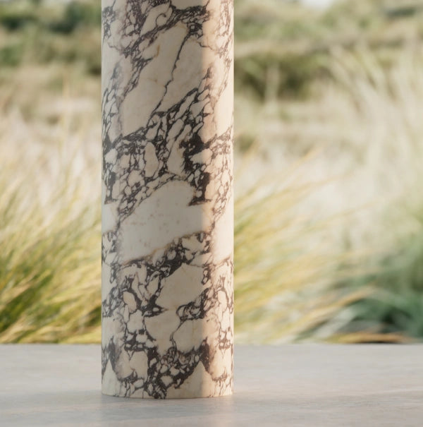 STRATA series round pedestal sink with faceted marble design